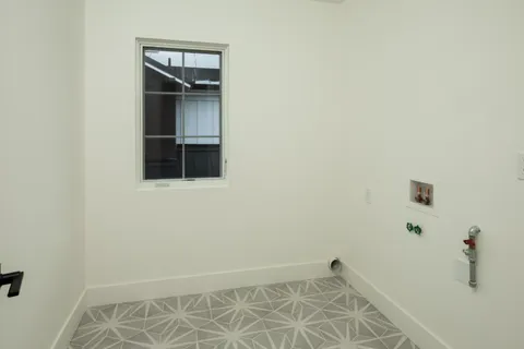 a view of an empty room with wooden floor and closet
