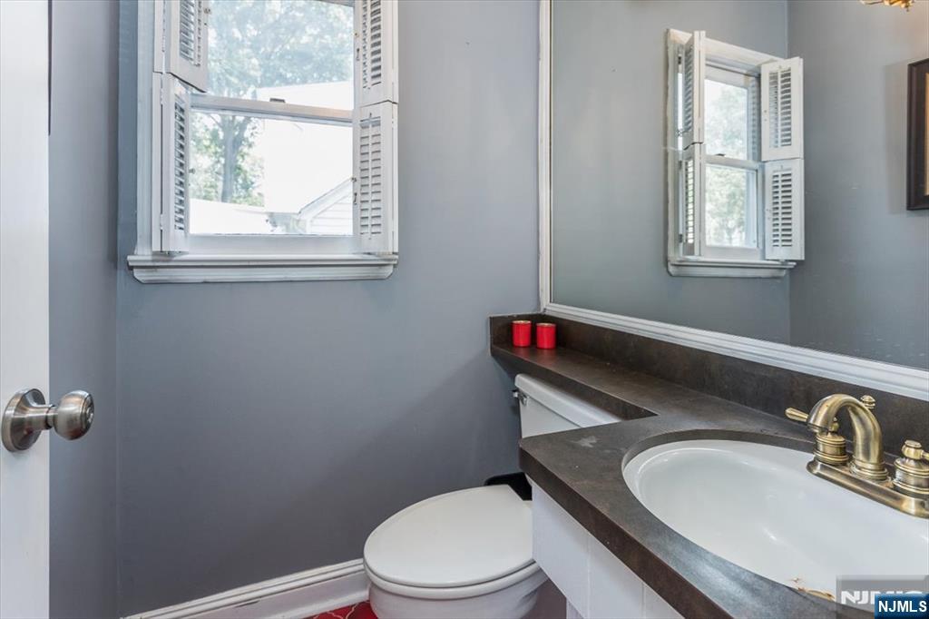 699 Kent Avenue Teaneck, NJ 07666 - Photo 13 of 31 a bathroom with a toilet sink and window