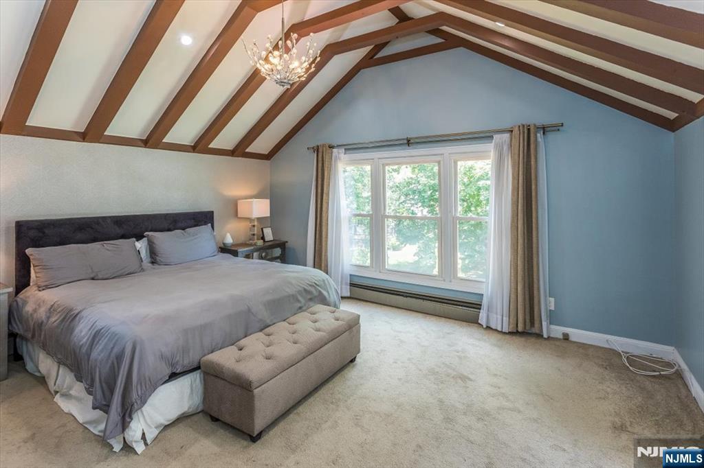 699 Kent Avenue Teaneck, NJ 07666 - Photo 17 of 31 a spacious bedroom with a bed and a large window