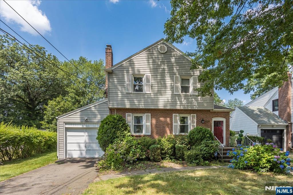 699 Kent Avenue Teaneck, NJ 07666 - Photo 2 of 31 a front view of a house with a yard and potted plants