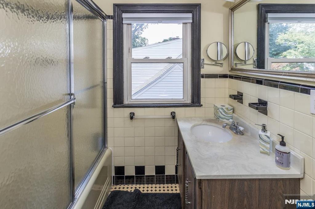 699 Kent Avenue Teaneck, NJ 07666 - Photo 21 of 31 a bathroom with a sink and a mirror