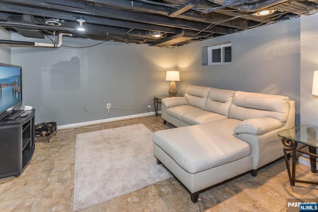 699 Kent Avenue Teaneck, NJ 07666 - Photo 22 of 31 a living room with furniture and a table