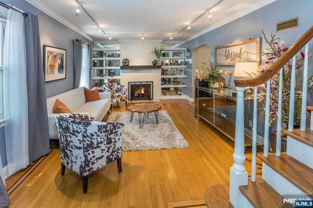 699 Kent Avenue Teaneck, NJ 07666 - Photo 7 of 31 a living room with furniture and a fireplace