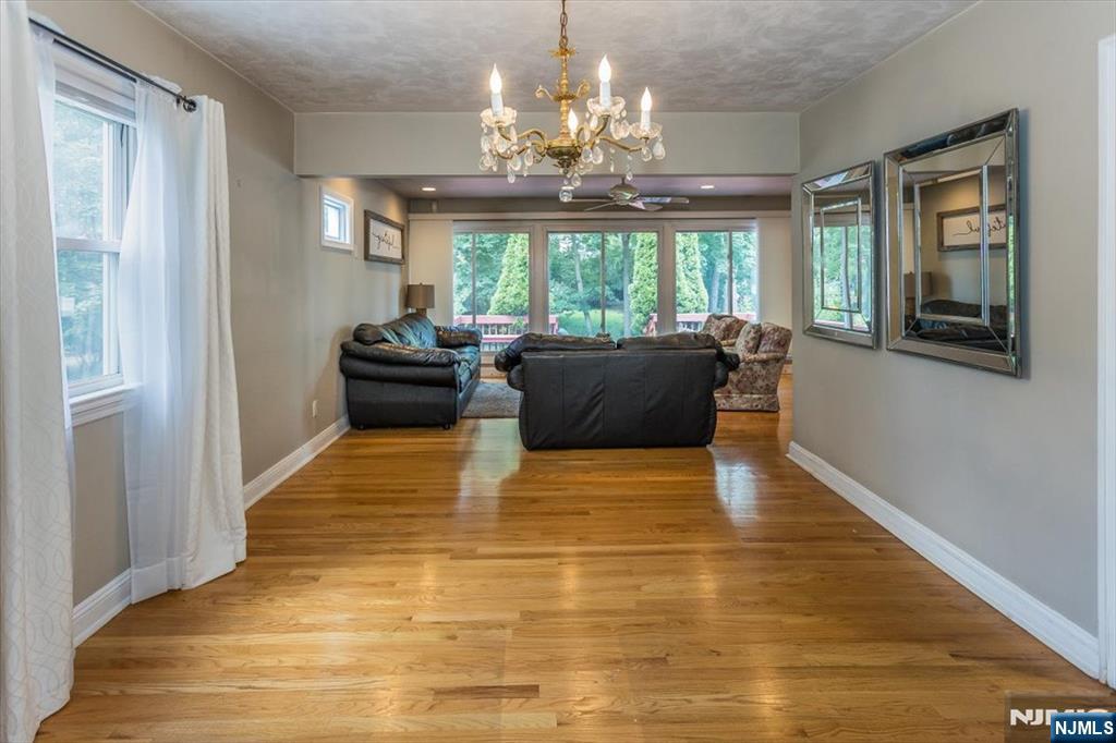 699 Kent Avenue Teaneck, NJ 07666 - Photo 8 of 31 a living room with furniture and a chandelier