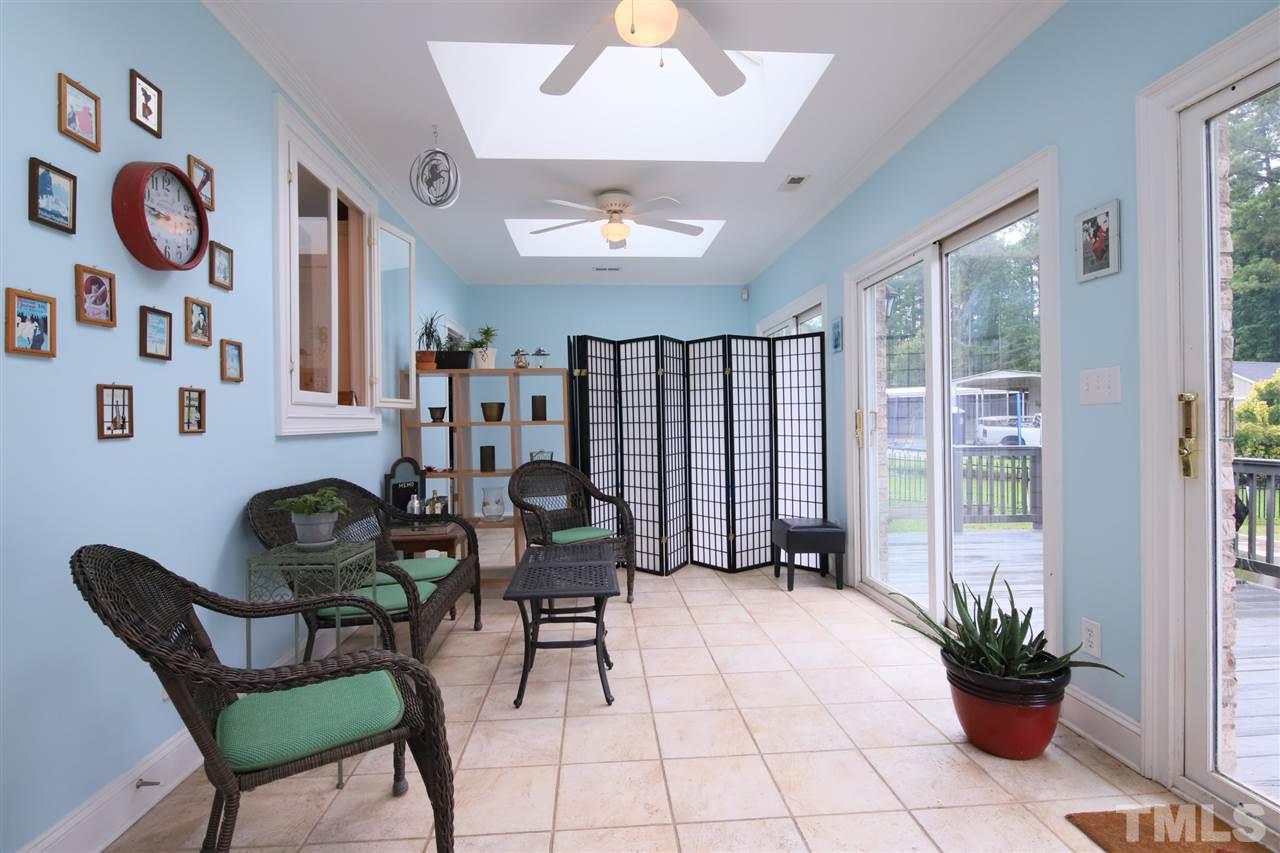 7012 Wildlife Trail Raleigh, NC 27613 - Photo 24 of 30 a living room with furniture and a potted plant