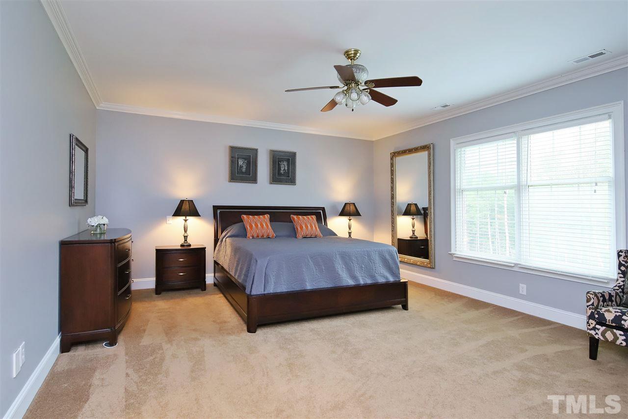 7012 Wildlife Trail Raleigh, NC 27613 - Photo 25 of 30 a spacious bedroom with a bed and a dresser