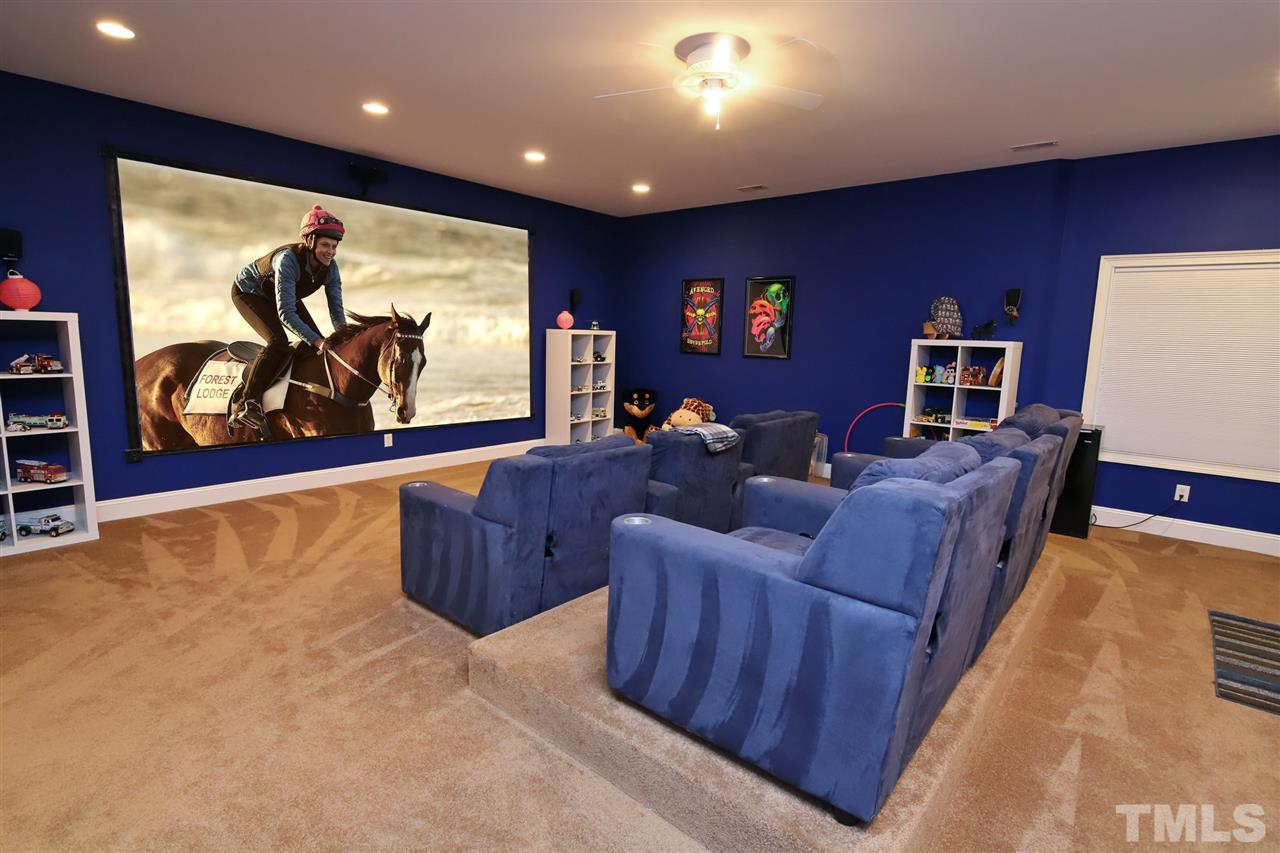 7012 Wildlife Trail Raleigh, NC 27613 - Photo 27 of 30 a living room with couches and a flat screen tv
