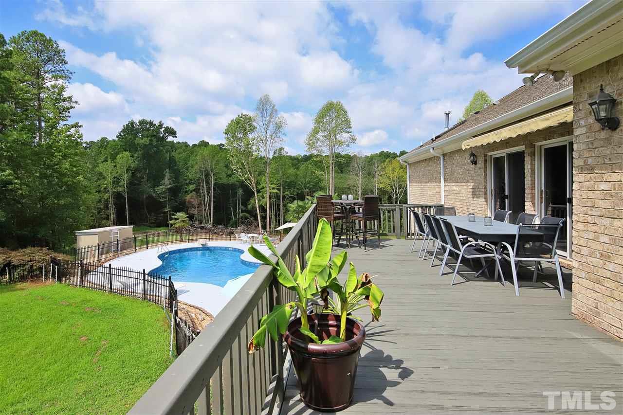 7012 Wildlife Trail Raleigh, NC 27613 - Photo 28 of 30 a view of a backyard with furniture and a garden