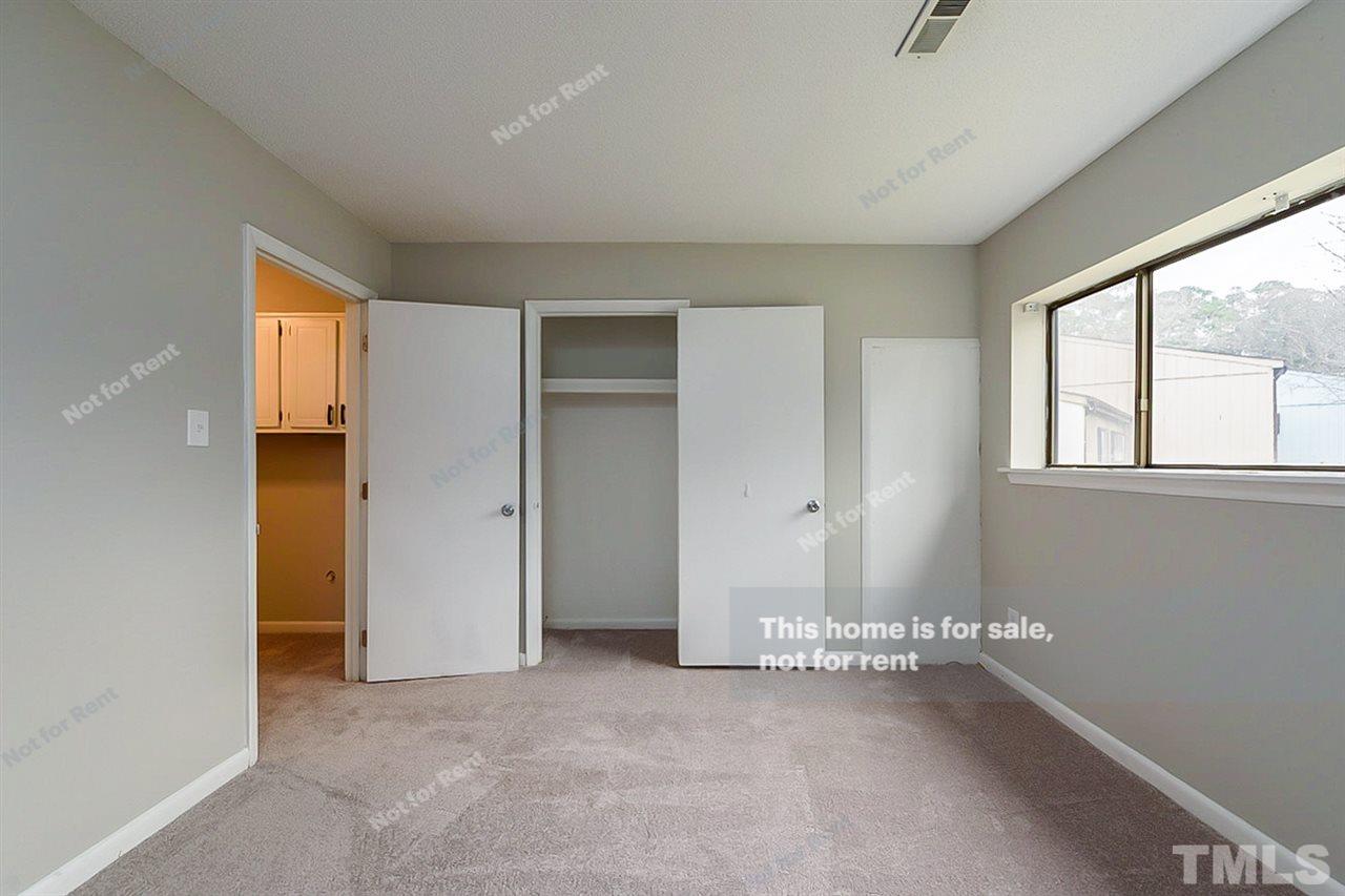 5132 Flint Ridge Place, Unit 5132 Raleigh, NC 27609 - Photo 14 of 14 an empty room with windows and closet