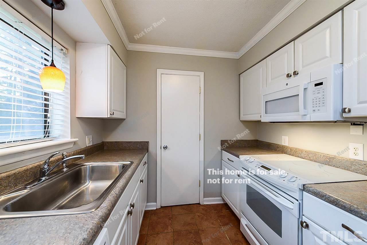 5132 Flint Ridge Place, Unit 5132 Raleigh, NC 27609 - Photo 8 of 14 a kitchen that has a sink and a stove