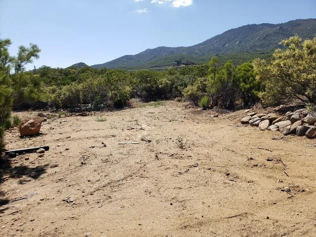 a view of a backyard of a house with a mountain