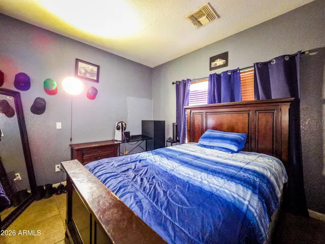 a kitchen with stainless steel appliances kitchen island granite countertop a table chairs and a refrigerator