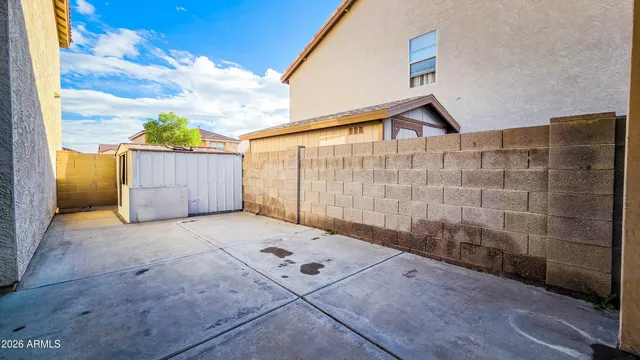 a backyard of a house with table and chairs