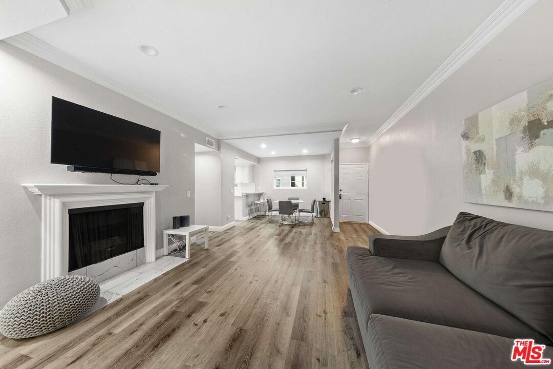 4301 Fulton Avenue, Unit 103 Sherman Oaks, CA 91423 - Photo 1 of 15 a living room with furniture and a fireplace