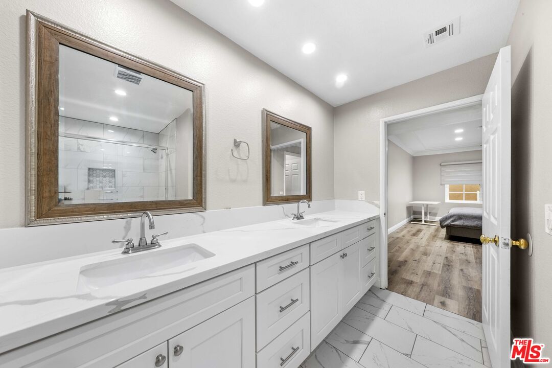 4301 Fulton Avenue, Unit 103 Sherman Oaks, CA 91423 - Photo 11 of 15 a en suite bathroom with double sink and a mirror