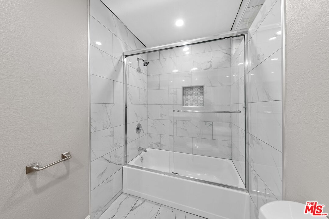 4301 Fulton Avenue, Unit 103 Sherman Oaks, CA 91423 - Photo 12 of 15 a bathroom with a bathtub and a shower