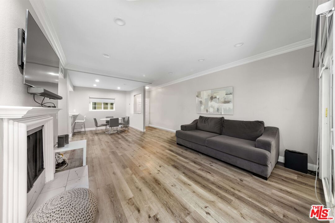 4301 Fulton Avenue, Unit 103 Sherman Oaks, CA 91423 - Photo 2 of 15 a living room with furniture and a fireplace
