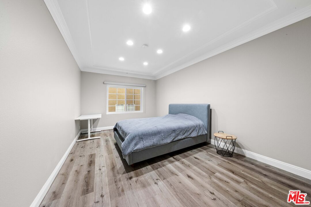 4301 Fulton Avenue, Unit 103 Sherman Oaks, CA 91423 - Photo 10 of 15 a bedroom with a bed and window