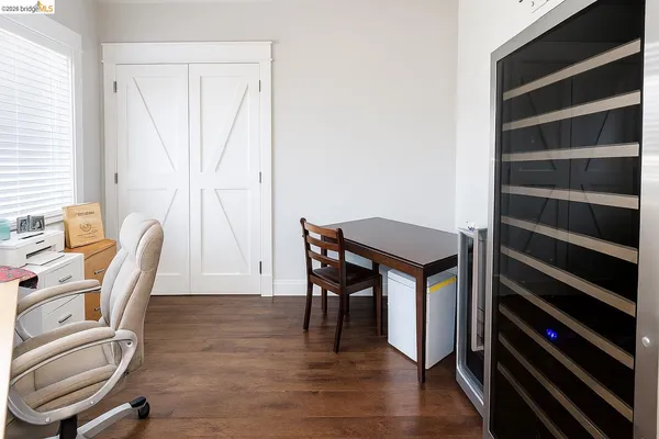 a view of a workspace with furniture and wooden floor