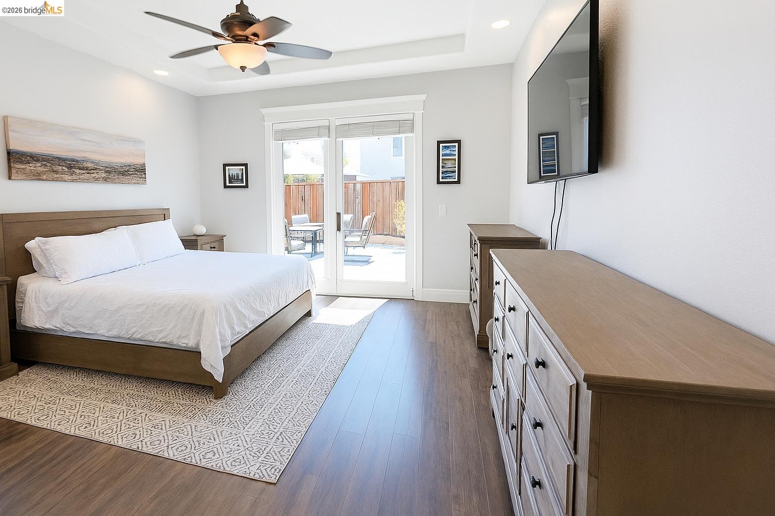 2072 Bridgeport Loop Discovery Bay, CA 94505 - Photo 12 of 26 Bedroom with dark wood-style floors, access to exterior, ceiling fan, recessed lighting, and a raised ceiling