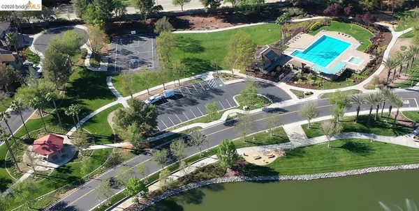 an aerial view of a house a yard and a swimming pool