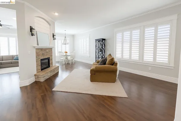 a living room with furniture wooden floor and a fireplace