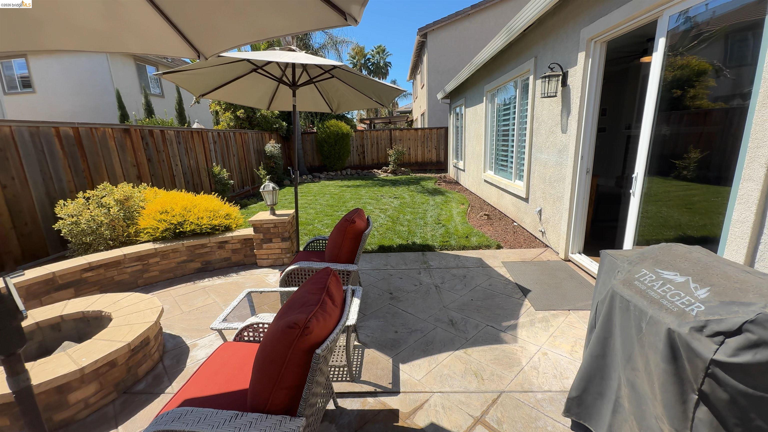 2072 Bridgeport Loop Discovery Bay, CA 94505 - Photo 21 of 26 Fenced backyard featuring a patio, grilling area, and a fire pit