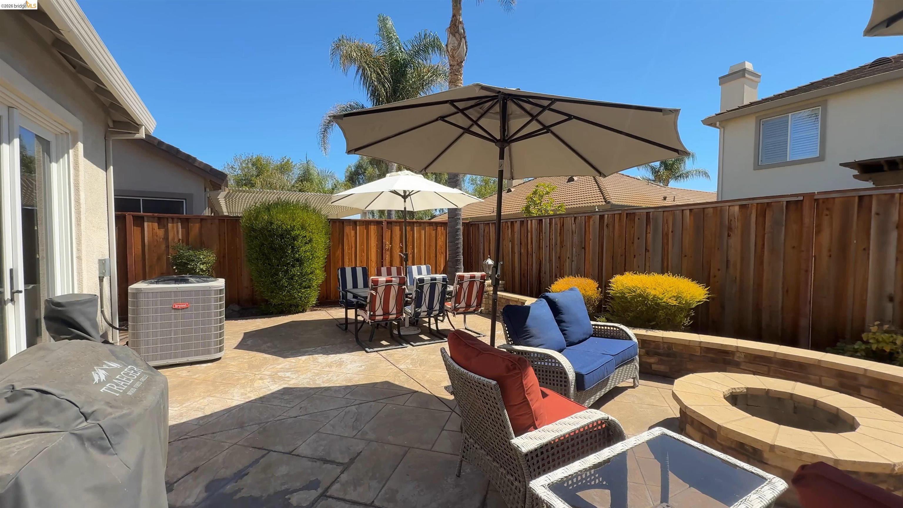 2072 Bridgeport Loop Discovery Bay, CA 94505 - Photo 22 of 26 Fenced backyard featuring a patio, grilling area, an outdoor living space with a fire pit, and outdoor dining space