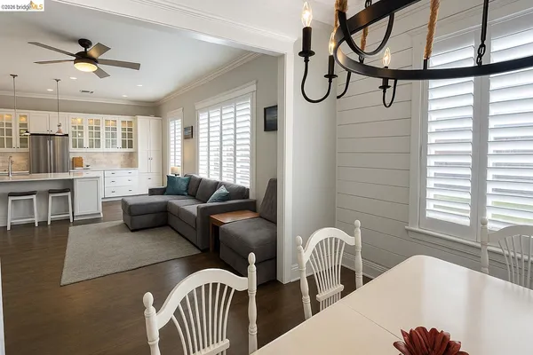 a living room with furniture a chandelier and a window