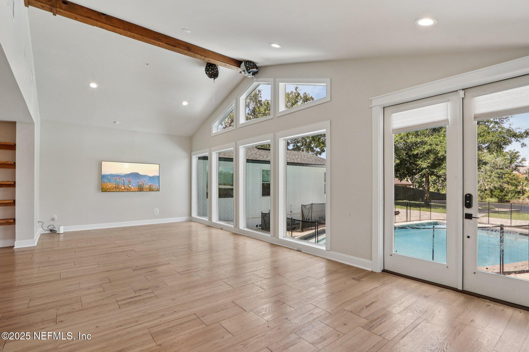1536 Mayfair Road Jacksonville, FL 32207 - Photo 13 of 58 an empty room with wooden floor and windows