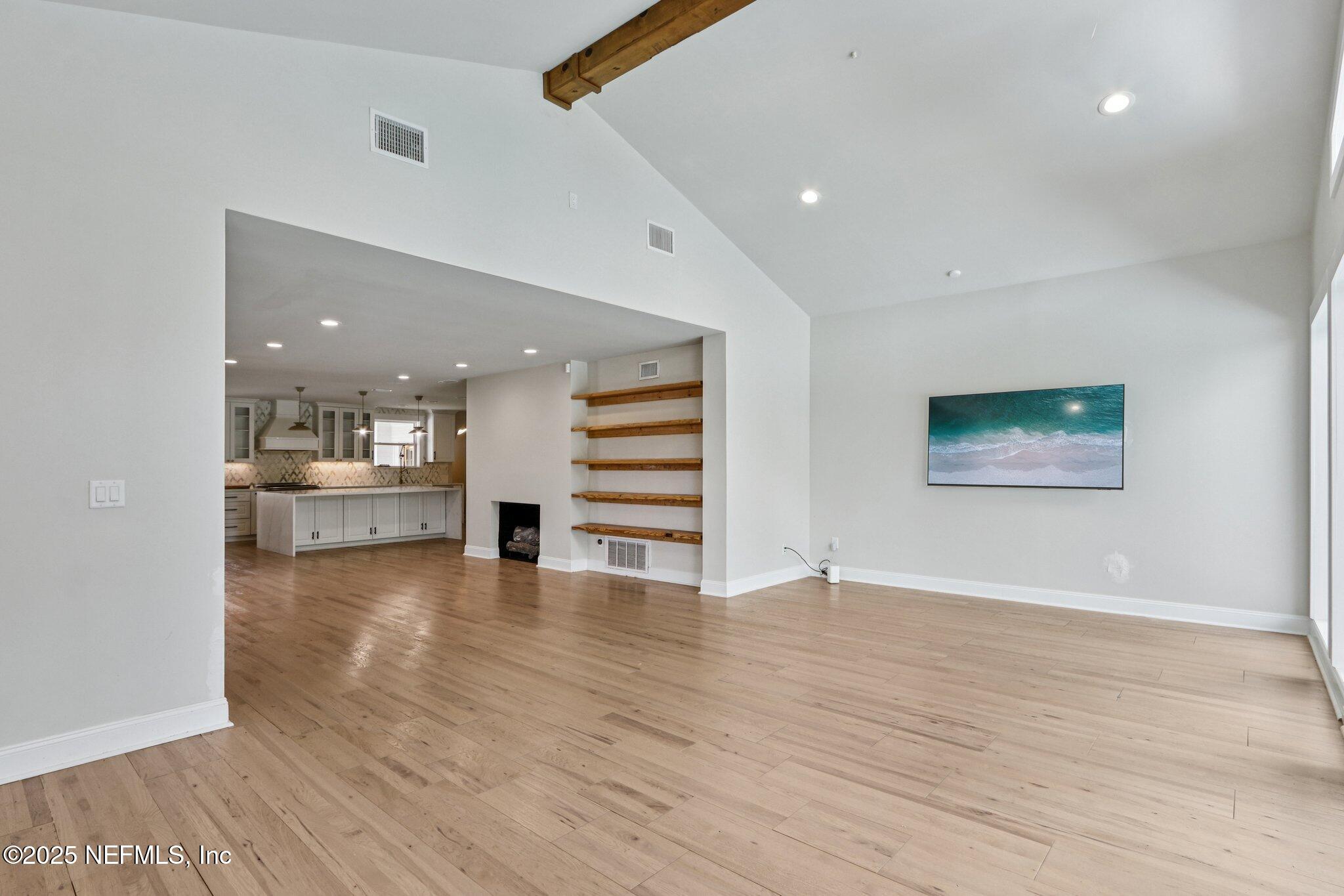 1536 Mayfair Road Jacksonville, FL 32207 - Photo 14 of 58 a view of an empty room with wooden floor and a cabinet