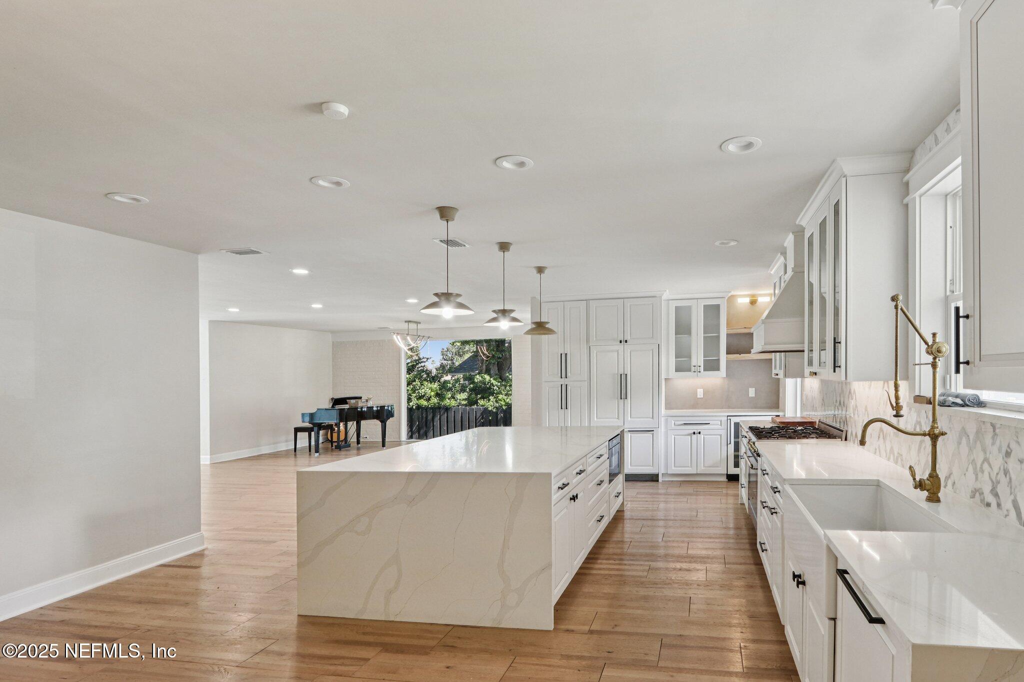 1536 Mayfair Road Jacksonville, FL 32207 - Photo 16 of 58 a large living room with stainless steel appliances kitchen island a large window in it
