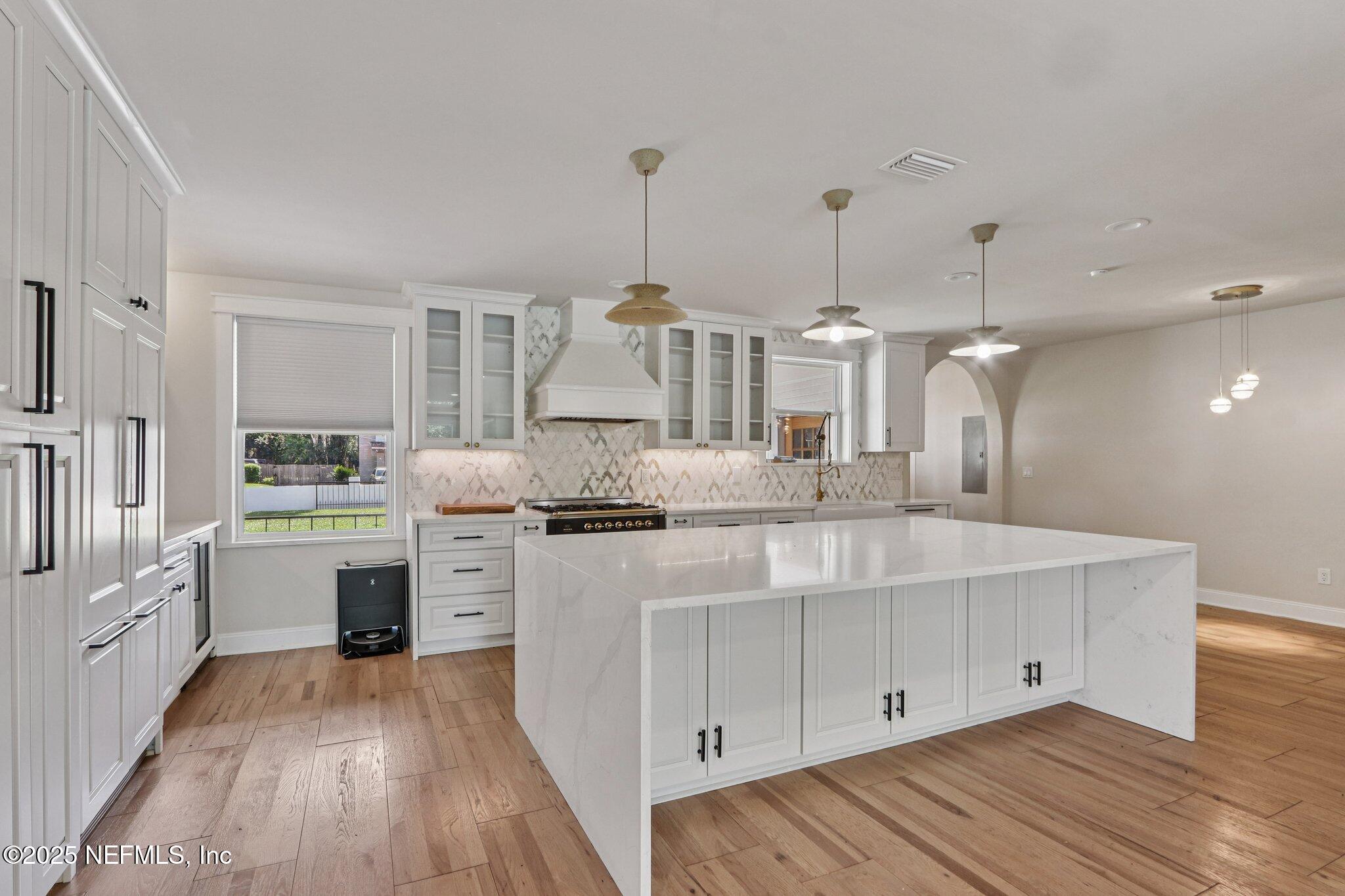 1536 Mayfair Road Jacksonville, FL 32207 - Photo 20 of 58 a kitchen with white cabinets and stainless steel appliances