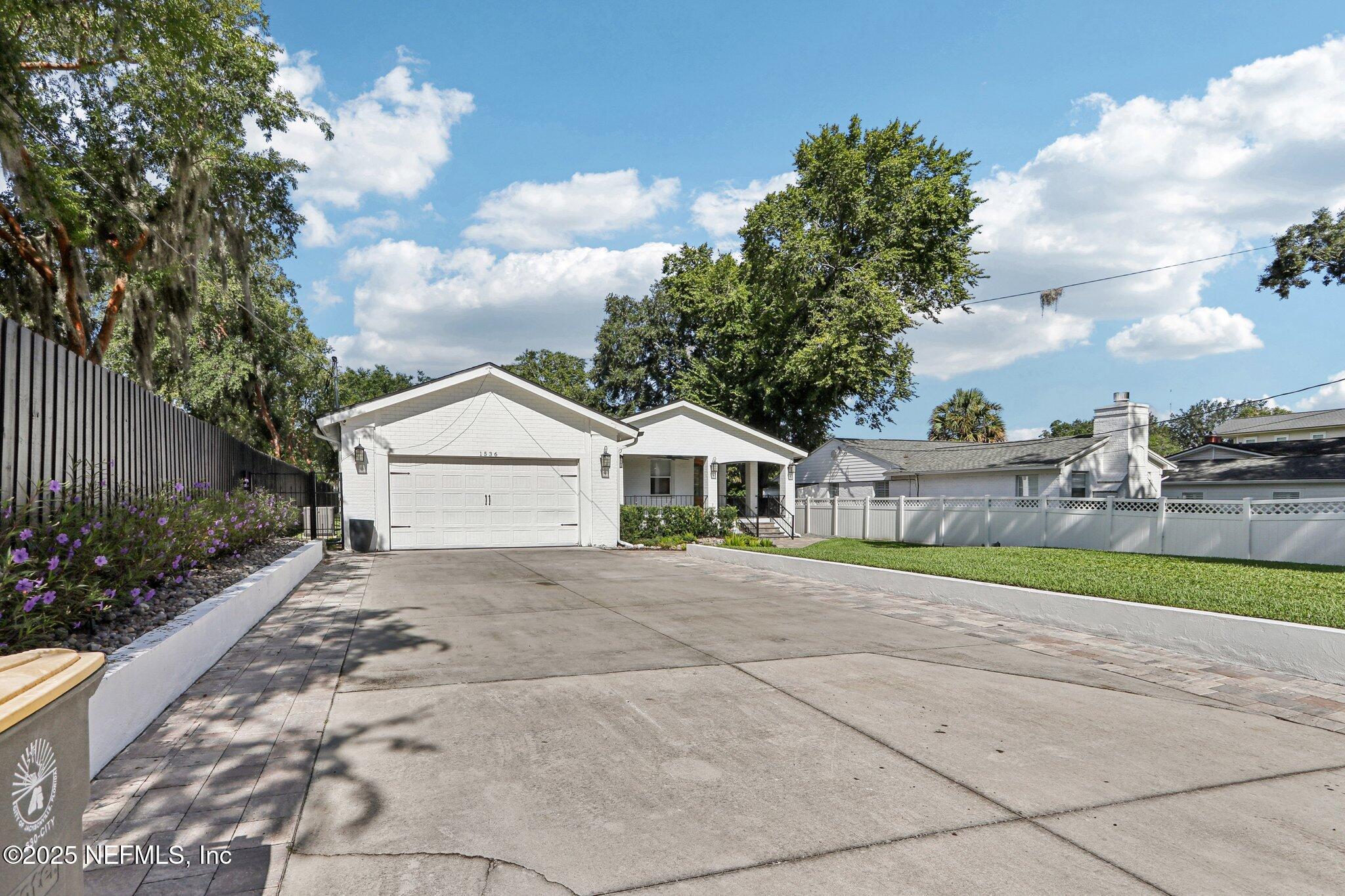 1536 Mayfair Road Jacksonville, FL 32207 - Photo 2 of 58 a view of yellow house with a big yard and large trees