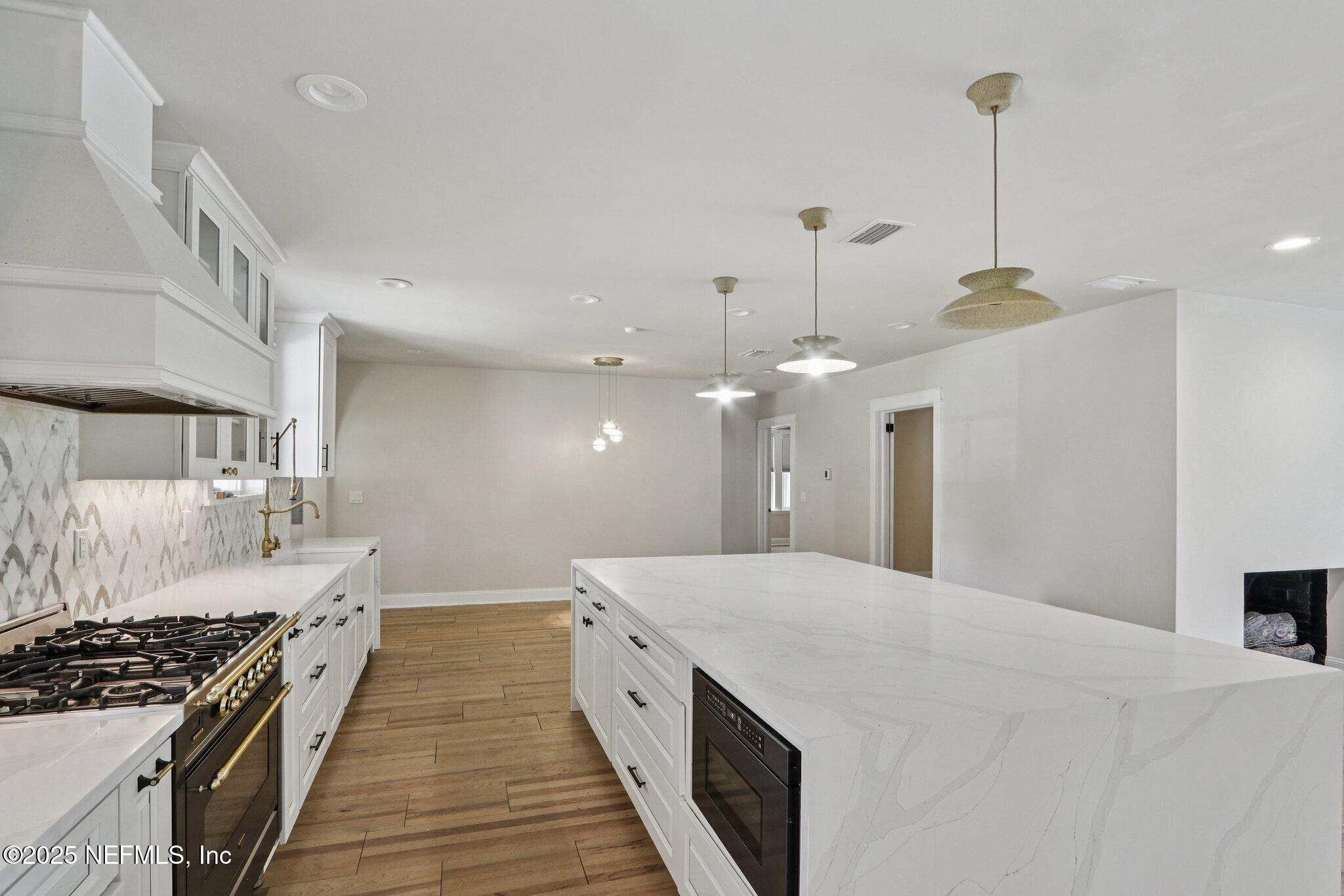 1536 Mayfair Road Jacksonville, FL 32207 - Photo 22 of 58 a large kitchen with kitchen island a stove a sink dishwasher and a wooden cabinets