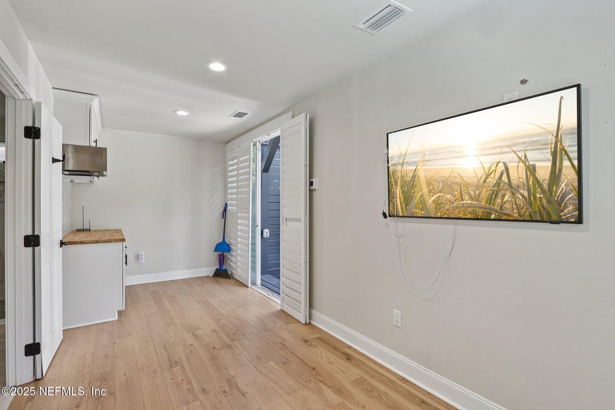 1536 Mayfair Road Jacksonville, FL 32207 - Photo 24 of 58 a view of a hallway with wooden floor and cabinet