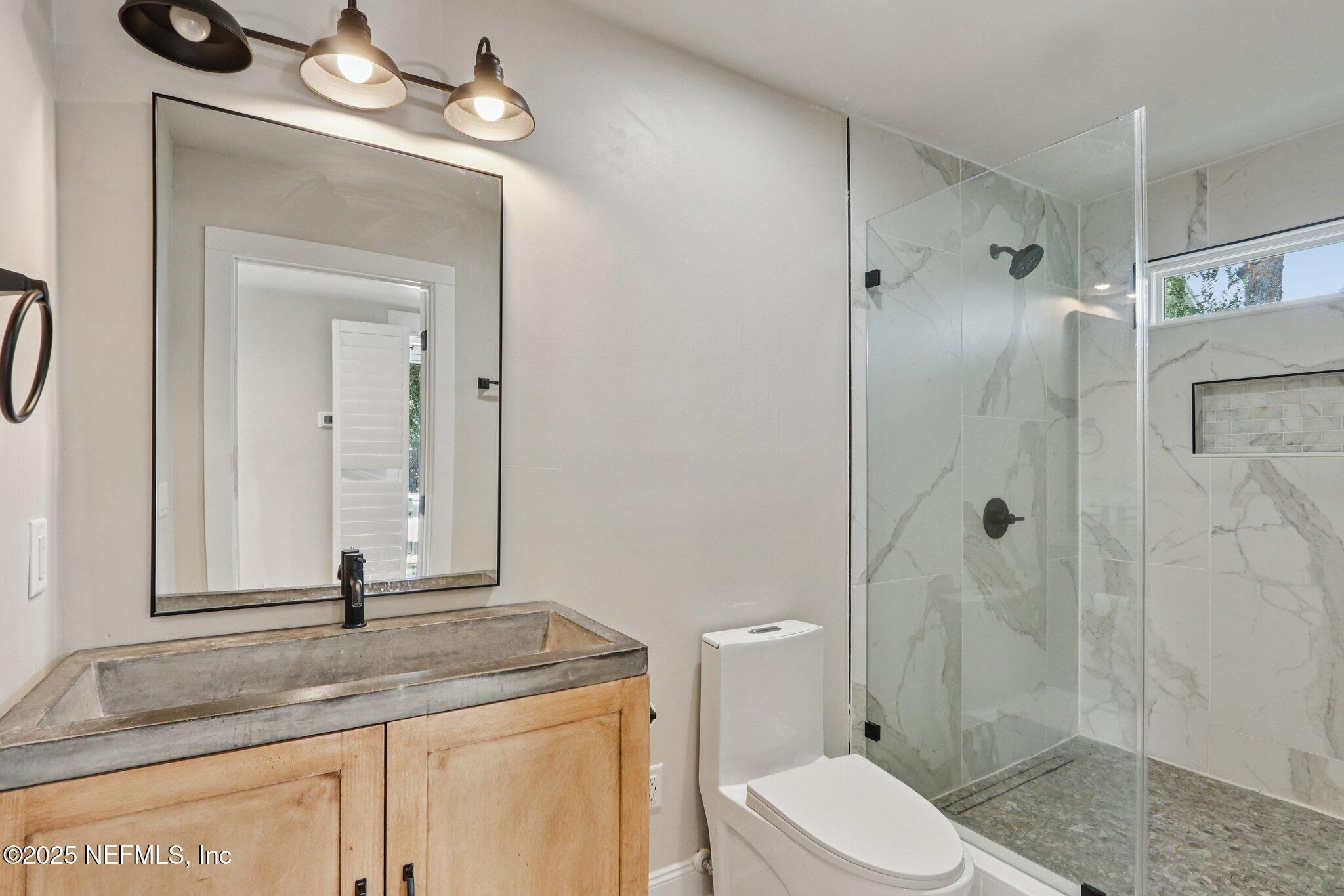 1536 Mayfair Road Jacksonville, FL 32207 - Photo 25 of 58 a bathroom with a granite countertop sink toilet and shower