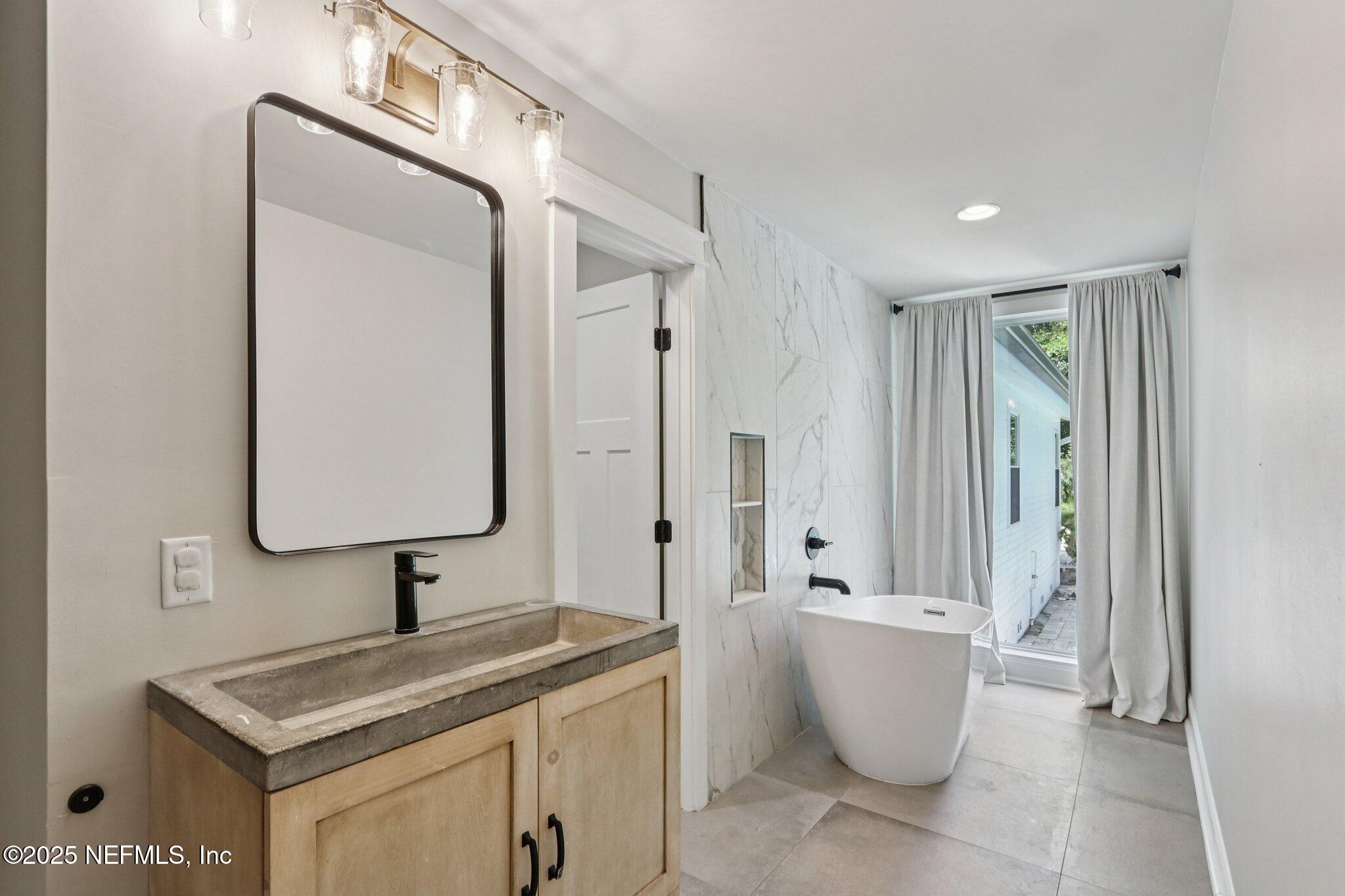 1536 Mayfair Road Jacksonville, FL 32207 - Photo 28 of 58 a bathroom with a granite countertop sink and a mirror