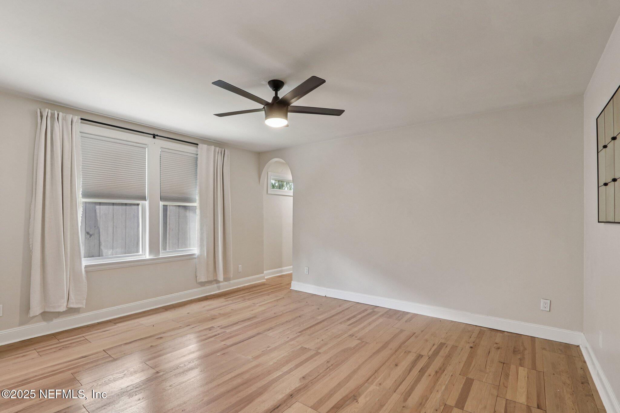 1536 Mayfair Road Jacksonville, FL 32207 - Photo 29 of 58 an empty room with wooden floor and windows