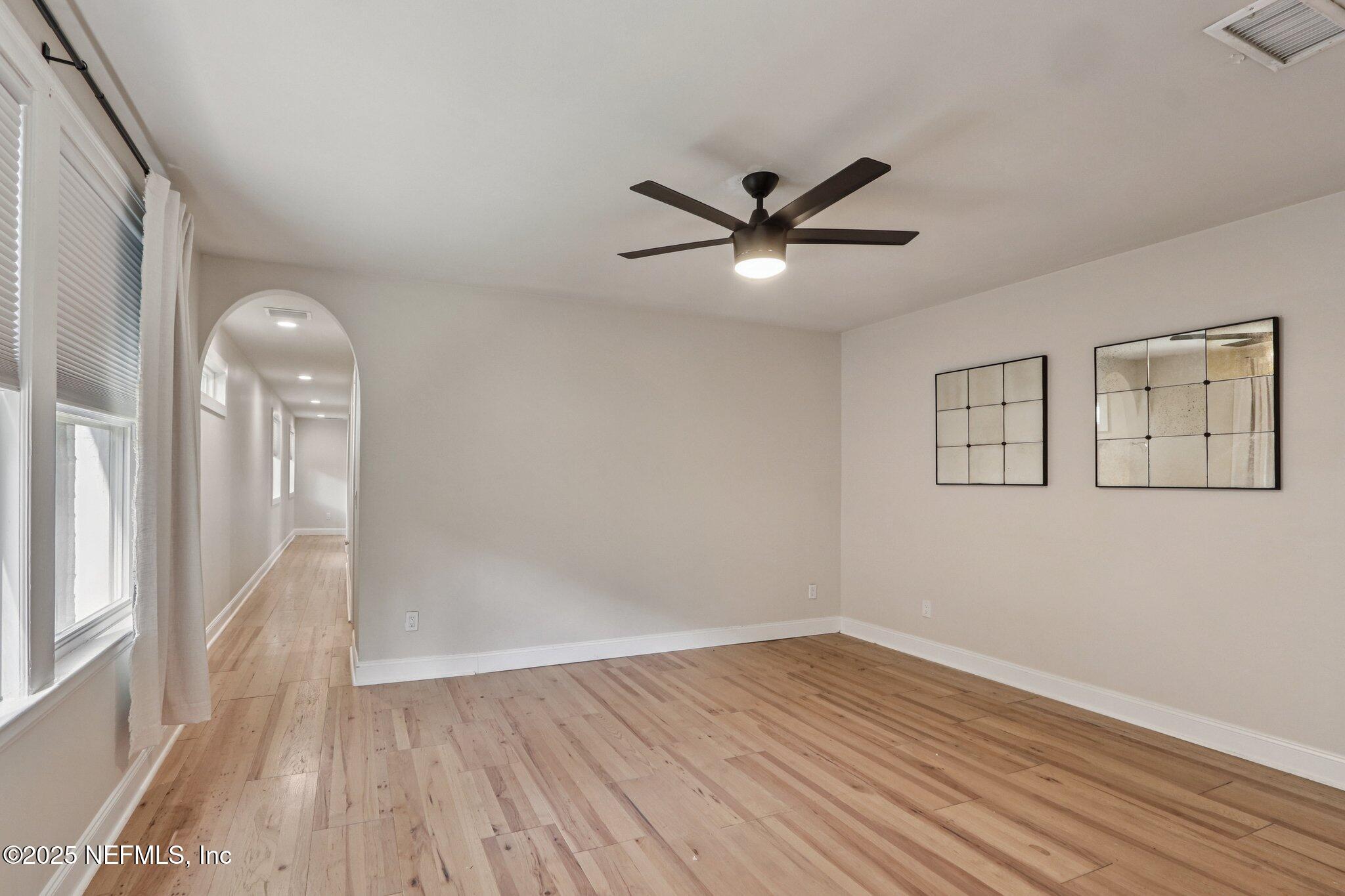 1536 Mayfair Road Jacksonville, FL 32207 - Photo 30 of 58 an empty room with wooden floor and windows