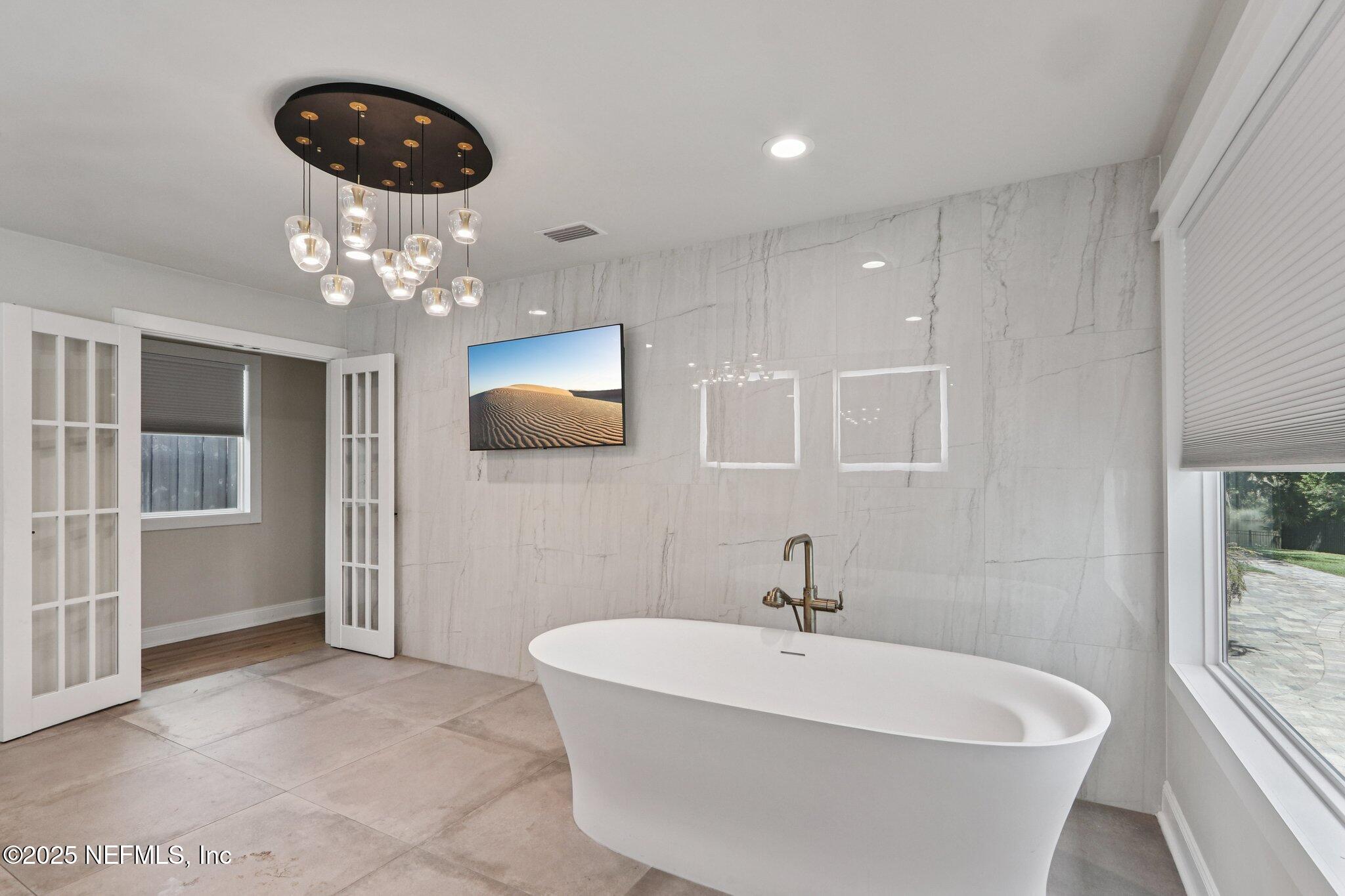 1536 Mayfair Road Jacksonville, FL 32207 - Photo 35 of 58 a white bath tub sitting in a bathroom and mirror