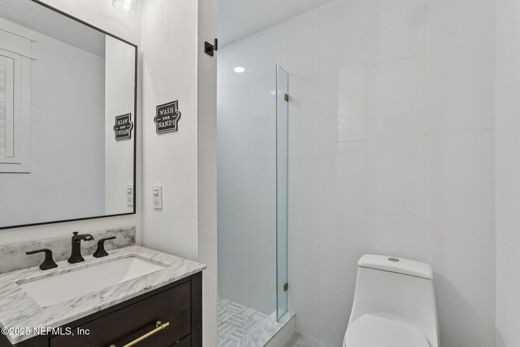 1536 Mayfair Road Jacksonville, FL 32207 - Photo 42 of 58 a bathroom with a sink a toilet and shower