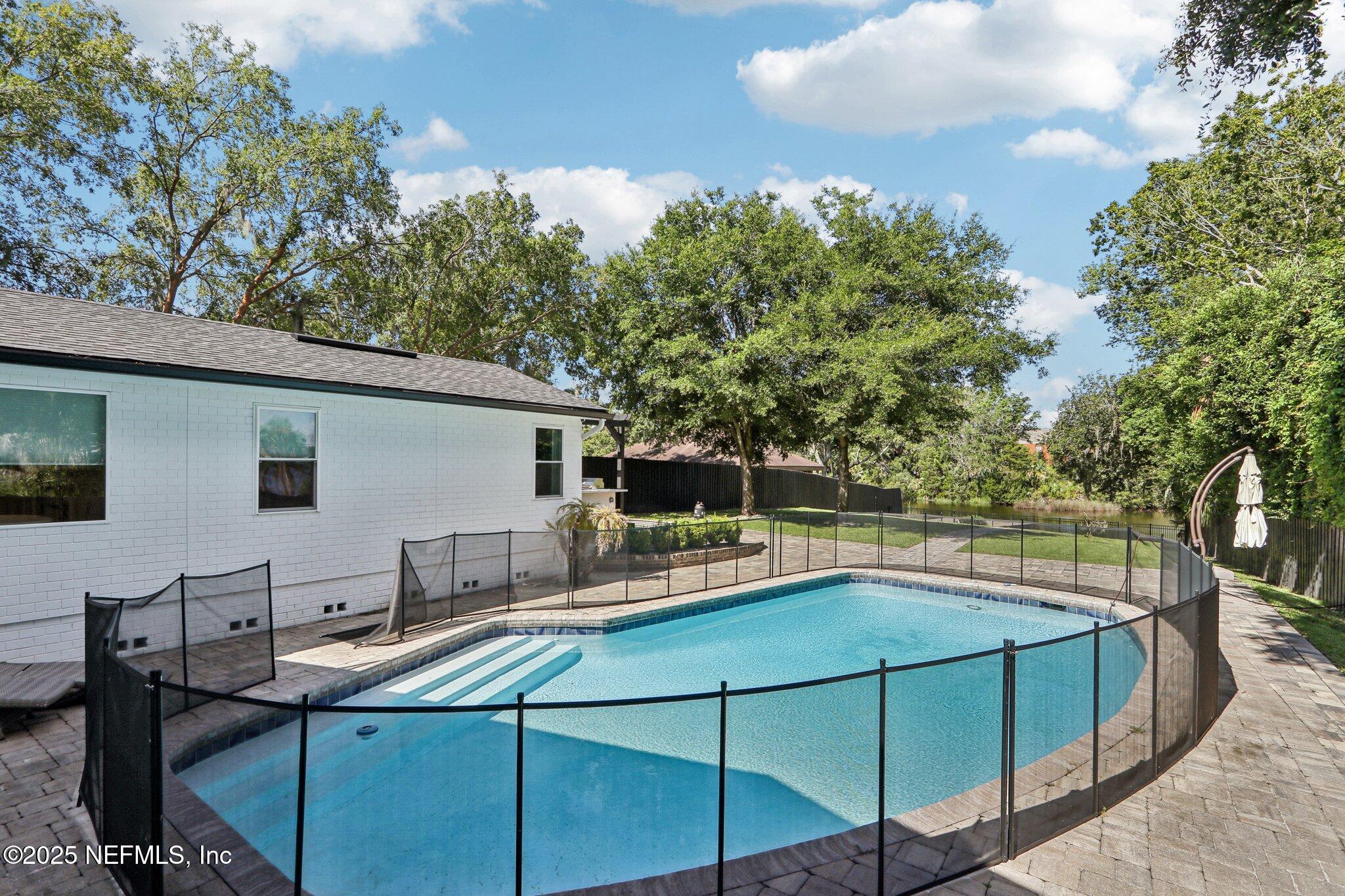 1536 Mayfair Road Jacksonville, FL 32207 - Photo 51 of 58 a view of a house with pool and chairs