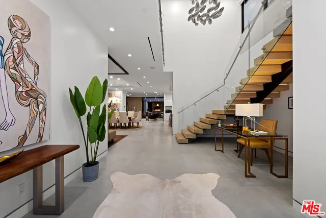a lobby with furniture and potted plants