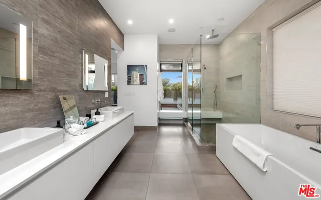 a bathroom with a bathtub a sink a toilet and a shower