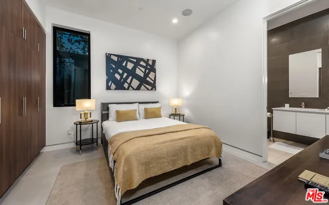 a bedroom with a bed and a view of bathroom