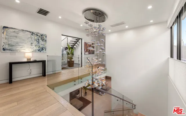 a view of a room with furniture and chandelier