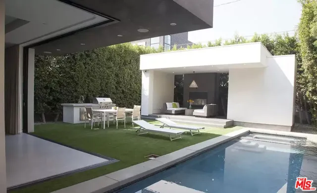 a view of a patio with table and chairs with wooden floor and fence