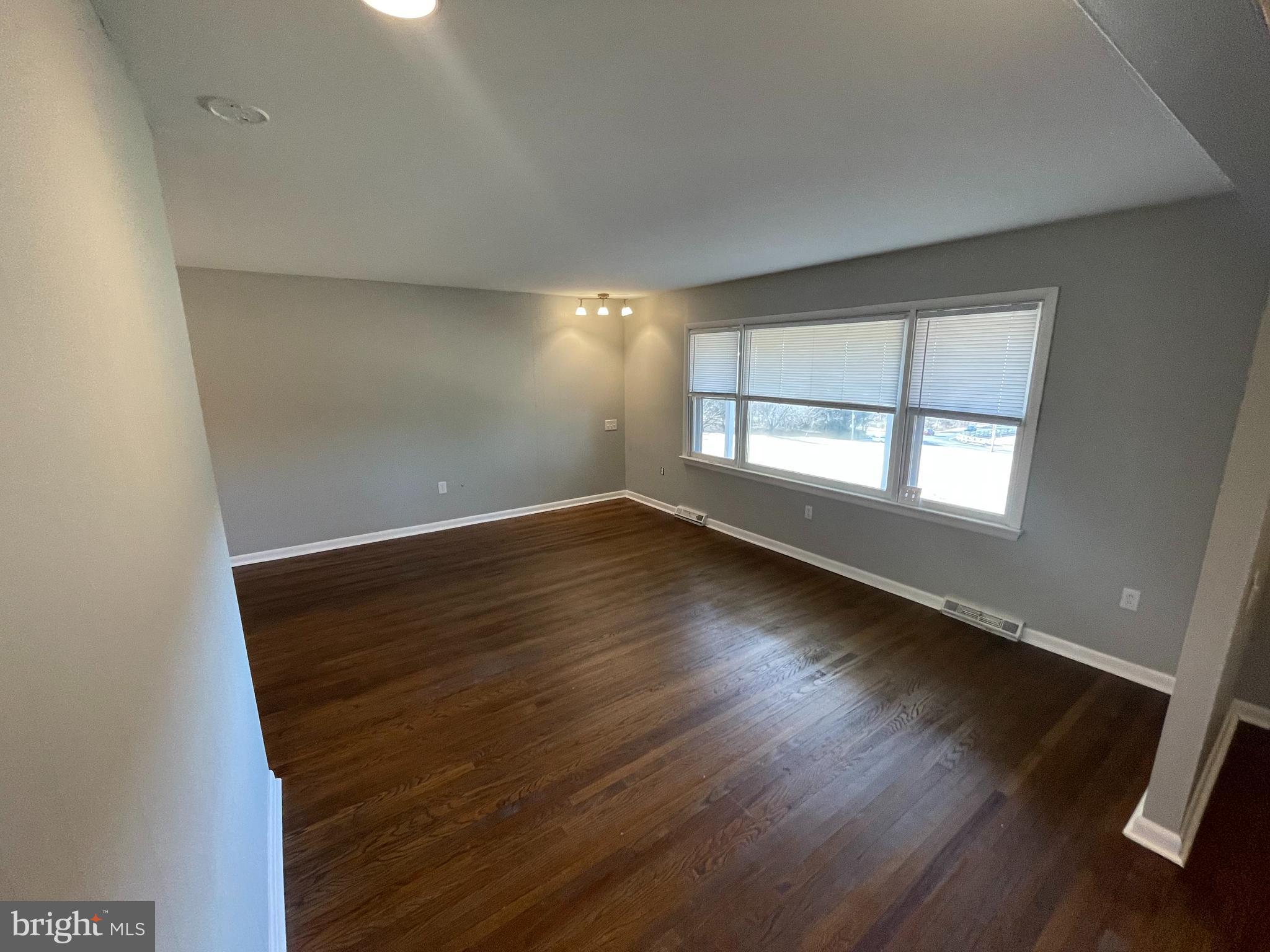 189 Morris Road Harleysville, PA 19438 - Photo 2 of 33 an empty room with wooden floor and windows