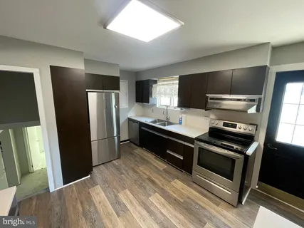 a kitchen with stainless steel appliances a refrigerator and a stove top oven